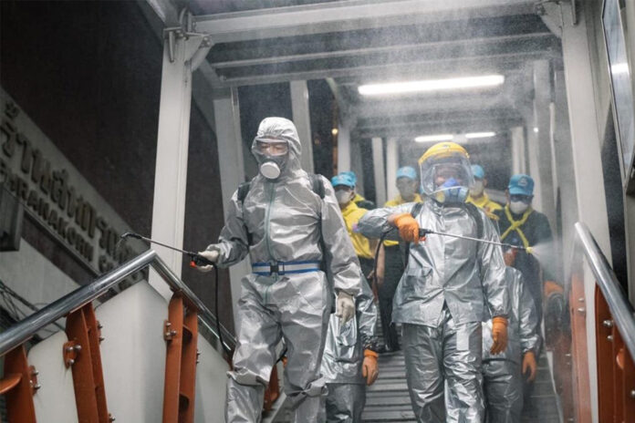 Army chief Gen. Apirat Kongsompong, left, and soldiers disinfect BTS Ari Station on March 24, 2020.