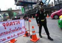 Thailand Reports New Virus Fatality, Raising the Death Toll to 5 A military police officer stands guard at a coronavirus checkpoint on Chaengwattana Road.