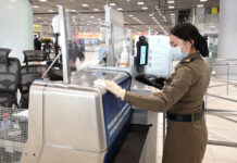 Gov’t Renews Visa Amnesty for Foreigners Stranded in Pandemic An immigration officer disinfects an immigration desk at Suvarnabhumi Airport on March 11, 2020.