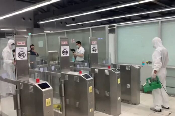 Workers disinfect biometric counters at Suvarnabhumi Airport on March 11, 2020.