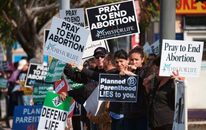 Protesters carry signs outside a Planned Parenthood health center in the Van Nuys section of Los Angeles, Feb. 11, 2017.Protesters carry signs outside a Planned Parenthood health center in the Van Nuys section of Los Angeles, Feb. 11, 2017. (Richard Vogel/AP Photo)