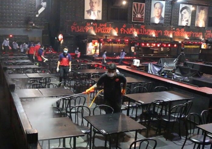 A worker disinfects a tavern in Khon Kaen on March 6, 2020, after a