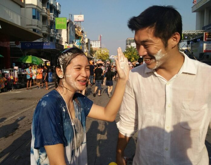 A Songkran reveler puts powder on Future Forward Party leader Thanathorn Juangroongruangkit in Khon Kaen on April 14, 2018.