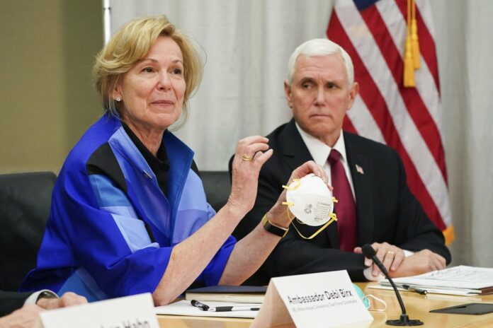 In this March 5, 2020, file photo, Dr. Deborah Birx, Ambassador and White House coronavirus response coordinator, holds a 3M N95 mask as Vice President Mike Pence visits 3M headquarters in Maplewood, Minn., in a meeting with 3M leaders and Minnesota Gov. Tim Walz to coordinate response to the COVID-19 virus. (Glen Stubbe/Star Tribune via AP, File)