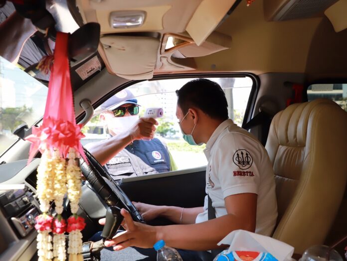 A motorist gets a body temperature check on March 27, 2020, in Bangkok.