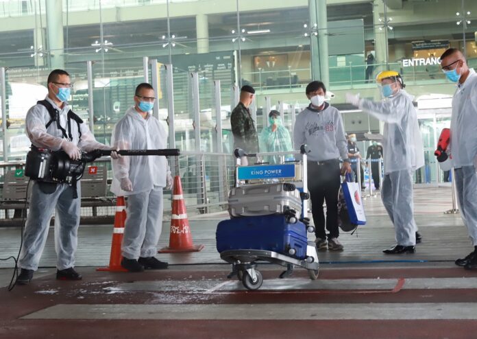 Security officers disinfect luggages at Suvarnabhumi Airport on April 17, 2020.