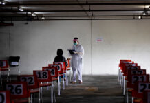 Economy May Expand by ‘4-5%’ Next Year, Finance Chief Says A nurse in protective clothing takes notes from a woman with symptoms of new coronavirus at a carpark that turned into a COVID-19 infection screening center at Chulalongkorn University's Health Service Center on April 1, 2020. Photo: Gemunu Amarasinghe / AP