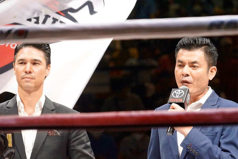 Pinit Polkhan, right, stands next to actor Matthew Deane Chanthavanij, who is also diagnosed with the coronavirus, left, during a boxing match at Lumpinee Boxing Stadium on March 6. Photo: matthew.deane1 / Instagram