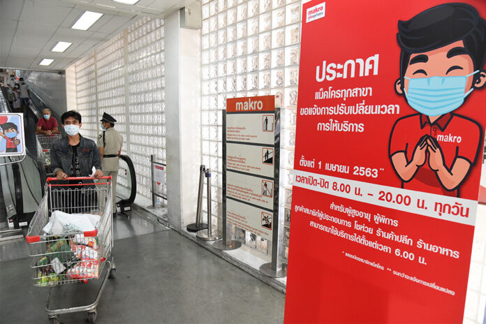 A sign at a Makro store in Bangkok telling customers the new business hours from 8am to 8pm.