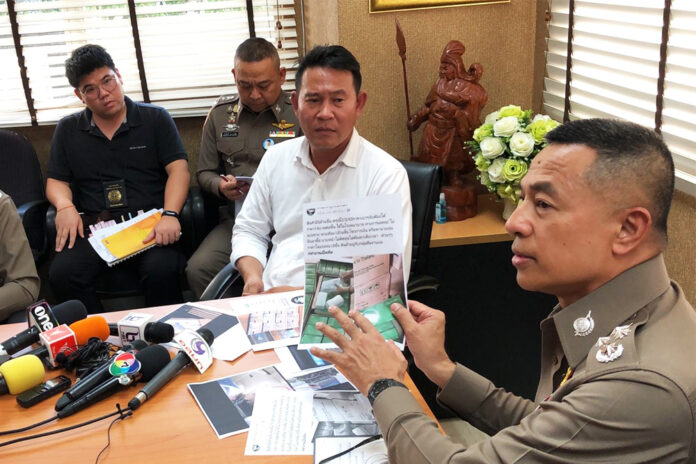 Police presents evidence to Sornsuvee Puraweeratwatcharee during his arrest on March 9, 2020.