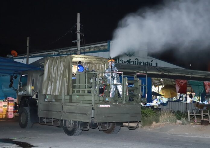 A soldier disinfects a market in Bangkok on the night of April 1, 2020.