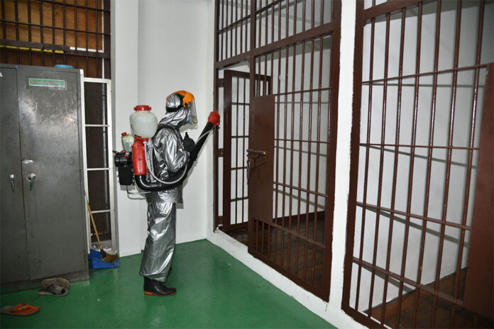 A jail inside Bang Khen Police Station being disinfected on March 30, 2020.