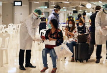 International Flights May Resume By September: Aviation Chief A health official in protective clothing talks to a woman at a health quarantine checkpoint at Suvarnabhumi Airport on April 16, 2020.