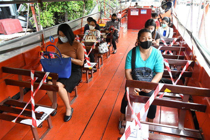 Seats on a Saen Saeb canal boat are marked for passengers to leave a space for social-distancing.