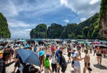 Tourist Arrivals to Thailand May Plunge by Two-Thirds A file photo of tourists crowding Maya Bay in southern Thailand.