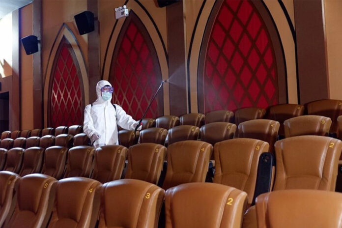 A worker disinfects cinema seats in Bangkok.