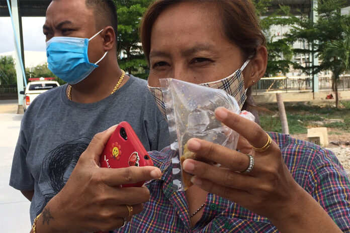 Thanu Changphuprangam's daughter shows a bag containing a piece of dumpling to the media on May 11, 2020.