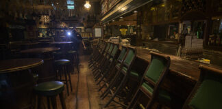Bangkok Orders Bar Closings To Stop Virus Spread In this April 21, 2020, file photo, a security guard is seen walking a round of patrol in the empty interior of Mulligan's, a popular Irish bar on Khaosan Road. Photo: Sirachai Arunrugstichai