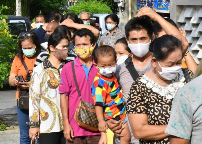 People line up to petition for government aid relief money on May 14, 2020 at the Government Public Relations Department in Bangkok.