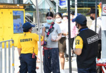 Policeman, 5 Others Infected With Coronavirus A woman gets her temperature checked before entering Chatuchak Weekend Market on May 9, 2020.
