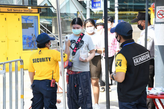 A woman gets her temperature checked before entering Chatuchak Weekend Market on May 9, 2020.