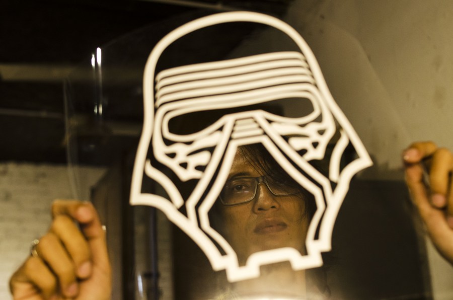 A man makes face shield protection with Star Wars character at his workshop in Bandung, Indonesia, June 17, 2020. Photo: Septianjar / Xinhua