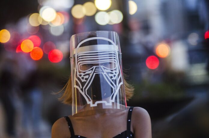 A woman wears face shield protection with Star Wars character in Bandung, Indonesia. June 17, 2020. Photo: Septianjar / Xinhua