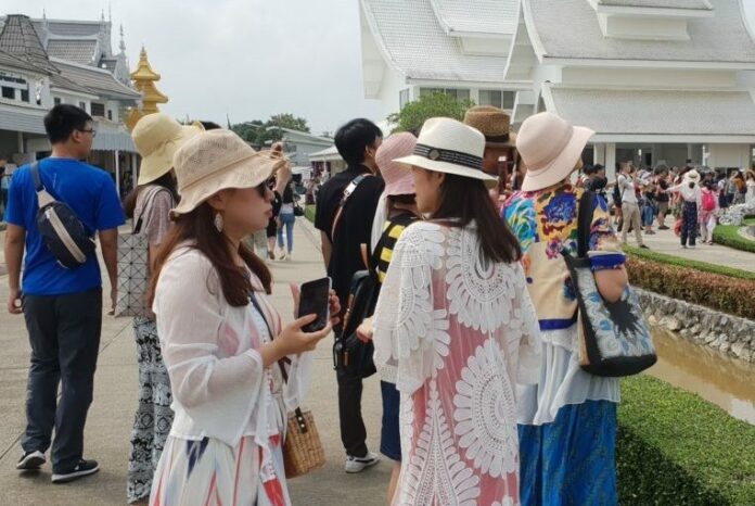 Tourists visit Wat Rong Kun in Chiang Rai province on Oct. 5, 2018.
