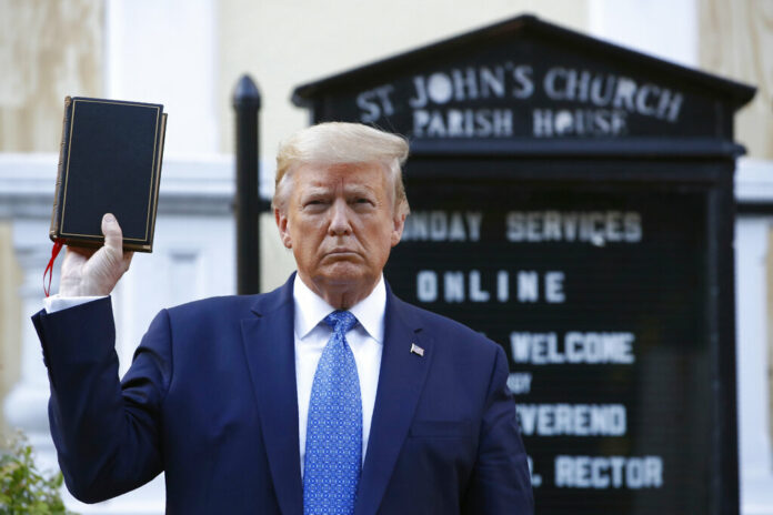 FILE - In this Monday, June 1, 2020 file photo, President Donald Trump holds a Bible as he visits outside St. John's Church across Lafayette Park from the White House. George Floyd’s killing at the hands of a white police officer and the global protests that erupted to denounce police brutality and racism might normally have drawn a muted diplomatic response from the Holy See. Francis spoke out Wednesday after Trump posed in front of an episcopal church near the White House, Bible in hand, after law enforcement moved aggressively to push back protesters from a nearby park. Photo: Patrick Semansky / AP File