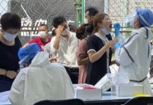 Beijing Expands Lockdowns as Cases Top 100 in New Outbreak Residents line up to get tested at a coronavirus testing center set up outside a sports facility in Beijing, Tuesday, June 16, 2020. China reported several dozen more coronavirus infections Tuesday as it increased testing and lockdown measures in parts of the capital to control what appeared to be its largest outbreak in more than two months. Photo: Ng Han Guan / AP