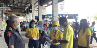 Bus Operator Confirms Ban on Foreign Travelers in Pandemic A passenger fills out a questionnaire before boarding a bus at Korat Bus Terminal on June 8, 2020.