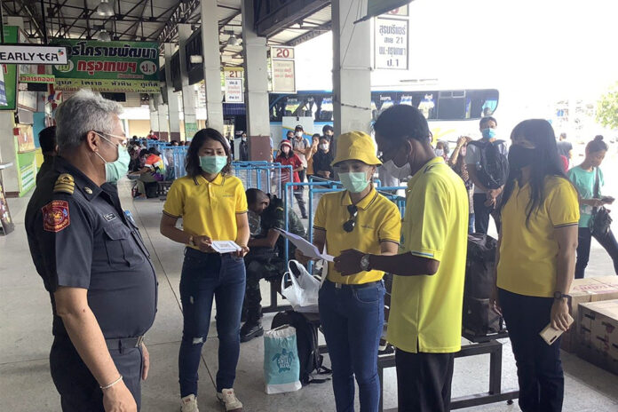 A passenger fills out a questionnaire before boarding a bus at Korat Bus Terminal on June 8, 2020.