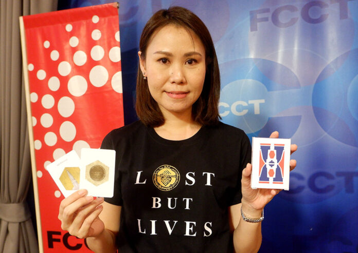 Nuttaa Mahattana wears a Tshirt with the 1932 Revolution Plaque and holds a 1932 revolt-themed card game on June 26, 2020 at the Foreign Correspondents’ Club of Thailand.