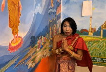 Temple Defies Order to Repaint Meme Picture on Mural Sitang Buathong stands next to the mural at Wat Nong Tao on June 3, 2020.