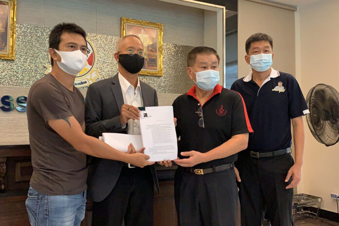 Sgt. Narongchai Intharakawi, left, submits his petition to Seri Ruam Thai MP Sereepisut Temiyaves, second from the right, on April 27, 2020.