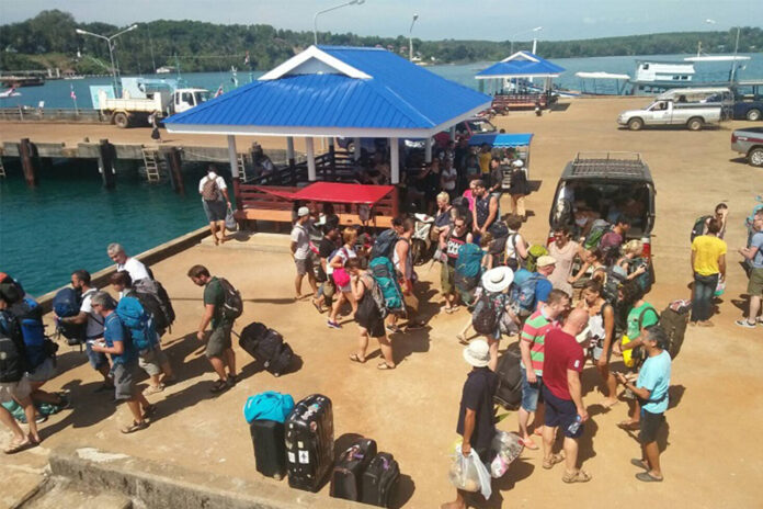 Tourists wait for a ferry on Koh Chang. Tourists wait for a ferry on Koh Chang.