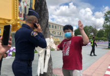 Activists Fined After Campaigning for Abducted Dissident Activist Parit Chiwarak being approached by a military officer in front of the Ministry of Defense on June 9, 2020.