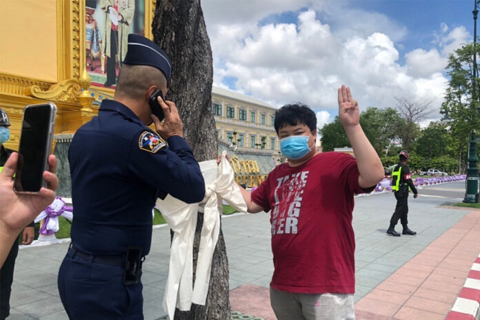 Activist Parit Chiwarak being approached by a military officer in front of the Ministry of Defense on June 9, 2020.