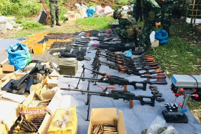 A photo released by the police shows a pile of weapons allegedly seized during a raid in Tak province on June 23, 2020. A photo released by the police shows a pile of weapons allegedly seized during a raid in Tak province on June 23, 2020.