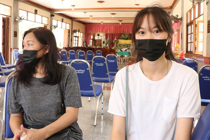 Pronrawin Ongpisut, right, at her father's funeral on July 20, 2020.