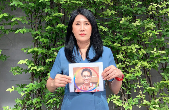 Sitanan Satsaksit holds a photo of Wanchalerm Satsaksit on July 30, 2020.