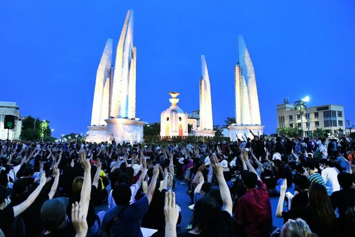 Protesters flash the anti-military 