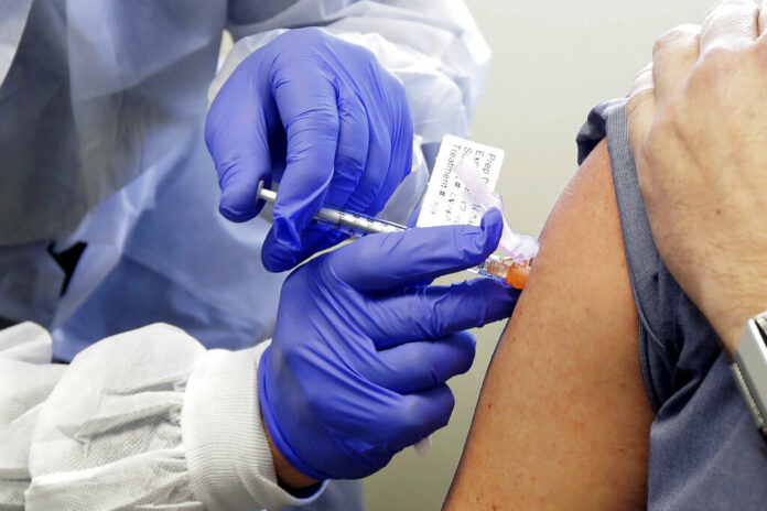 FILE - In this March 16, 2020, file photo, a subject receives a shot in the first-stage safety study clinical trial of a potential vaccine by Moderna for COVID-19, the disease caused by the new coronavirus, at the Kaiser Permanente Washington Health Research Institute in Seattle. According to results released on Tuesday, July 14, 2020, early-stage testing showed the first COVID-19 vaccine tested in the U.S. revved up people’s immune systems the way scientists had hoped. The vaccine is made by the National Institutes of Health and Moderna Inc. Photo: Ted S. Warren / AP File FILE - In this March 16, 2020, file photo, a subject receives a shot in the first-stage safety study clinical trial of a potential vaccine by Moderna for COVID-19, the disease caused by the new coronavirus, at the Kaiser Permanente Washington Health Research Institute in Seattle. According to results released on Tuesday, July 14, 2020, early-stage testing showed the first COVID-19 vaccine tested in the U.S. revved up people’s immune systems the way scientists had hoped. The vaccine is made by the National Institutes of Health and Moderna Inc. Photo: Ted S. Warren / AP File