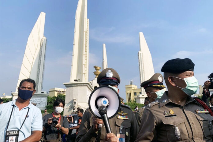 Police address the protesters at the Democracy Monument on July 18, 2020.