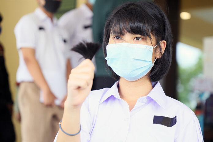 A student activist holds a trimmed hair during a protest at the Ministry of Education on July 3, 2020.
