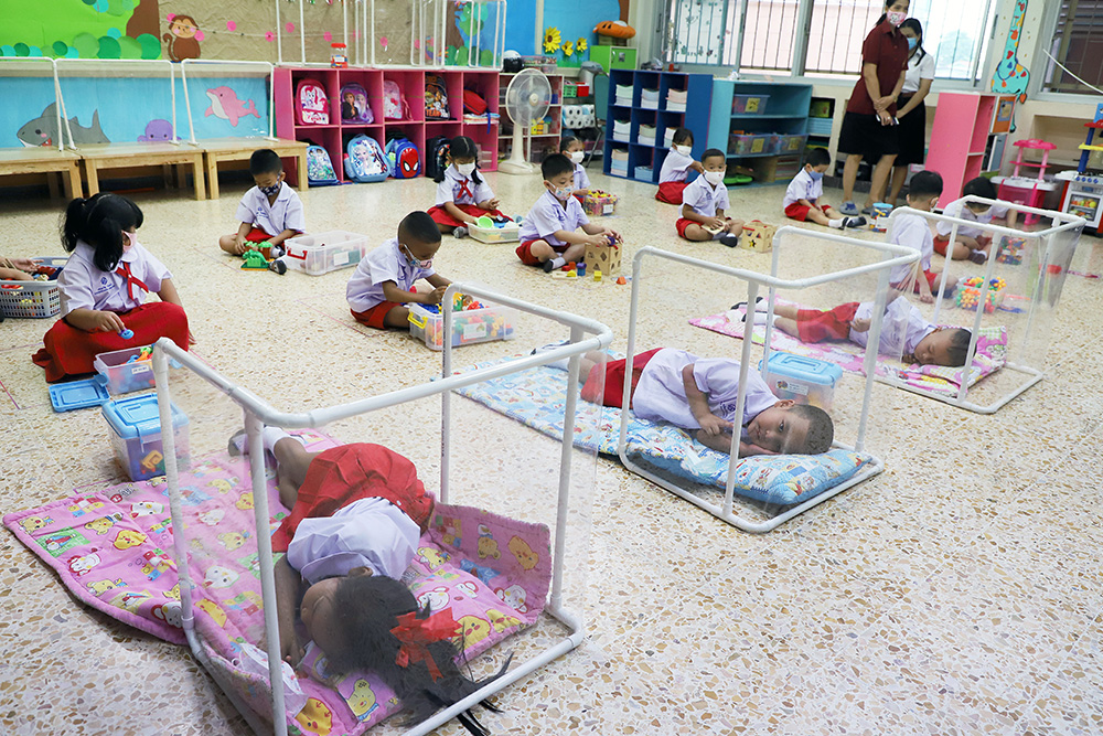 Plastic barrriers are installed around futon beds at Prachaniwet School.