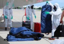 Colleagues of Pilot Found With Virus Were Allowed to Leave Quarantine Airport workers on July 9, 2020, disinfect luggage carried on a plane carrying Chief of Staff of the U.S. Army Gen. James McConville to Thailand.