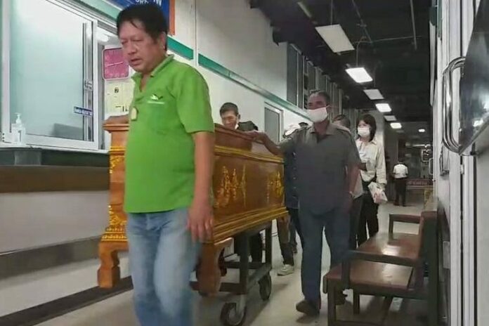 A coffin carrying Jaruchart Mardthong's body is wheeled to a forensic investigation on Aug. 3, 2020.