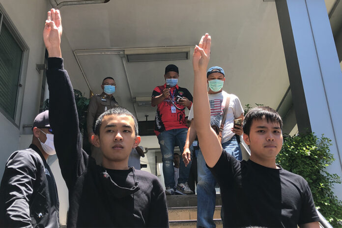 Panumas Singprom, left, and Tattep Ruangprapaikitseree, right, at Samranrat Police Station on Aug. 26, 2020.