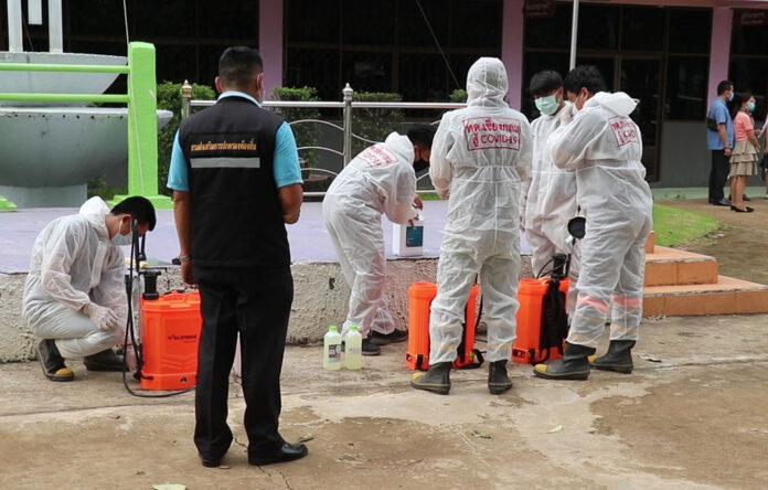Health officials disinfect Chiangklom Wittaya School in Loei on Aug. 20, 2020.